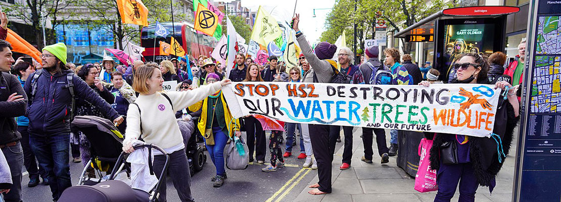 'Stop HS2' supporters with placards march along Oxford Street